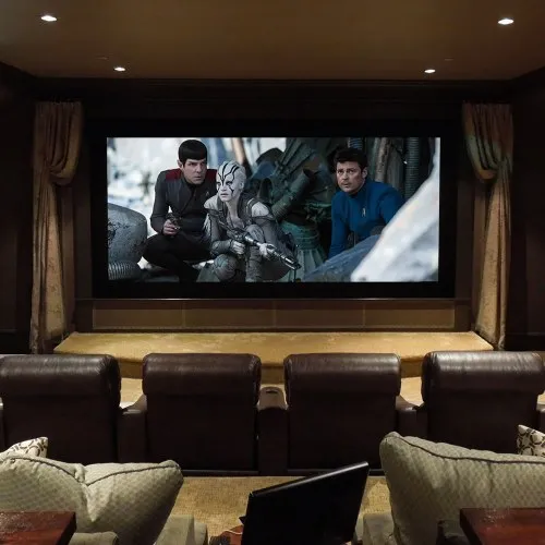 Private theater with a large screen and leather recliners