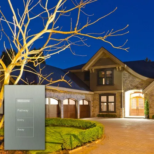 House exterior lit at dusk with a lighting keypad