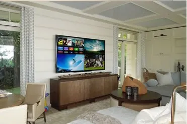 Living room with a wall-mounted television above a media console